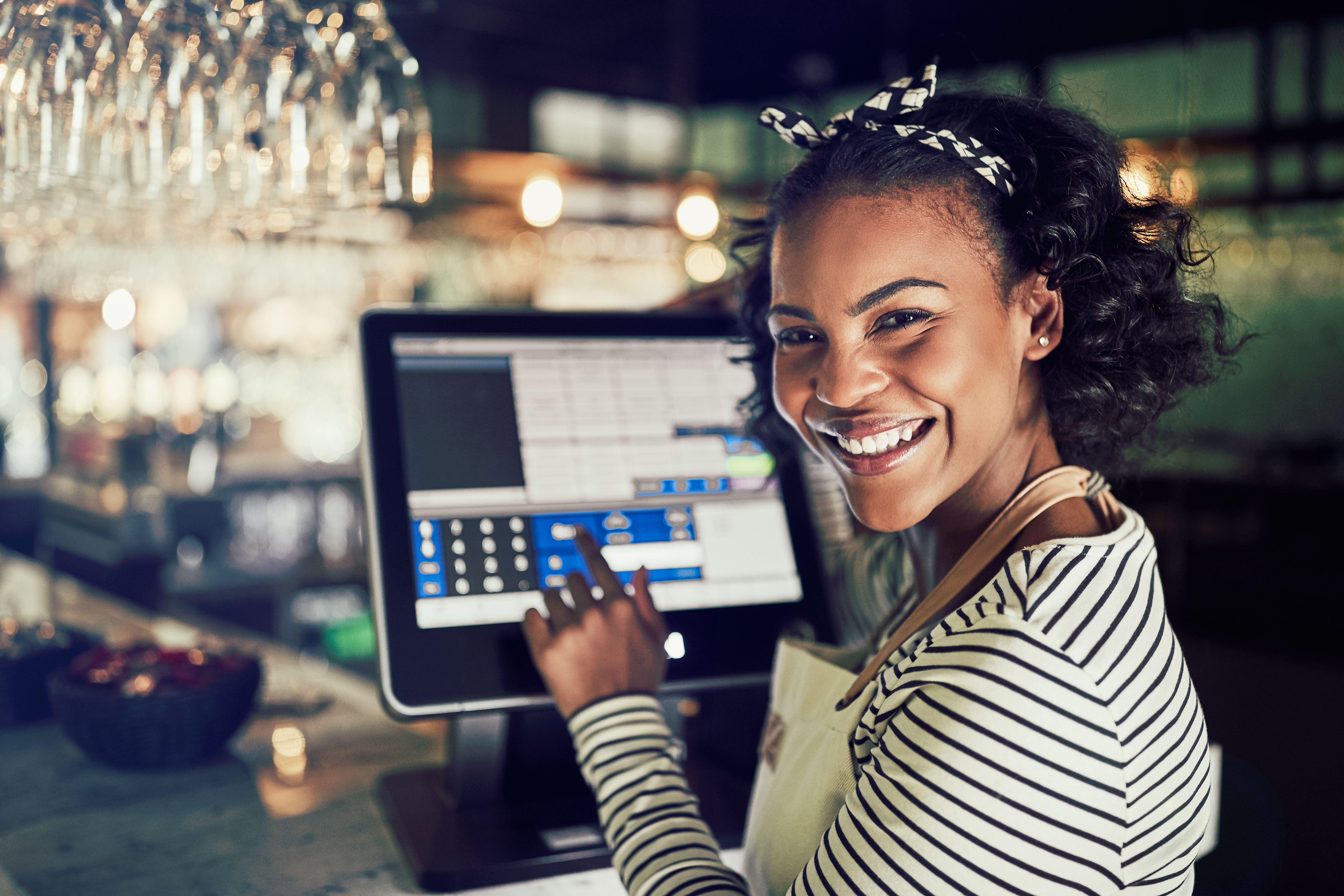 Woman enjoying the outcome of her outsourced restaurant IT installation.