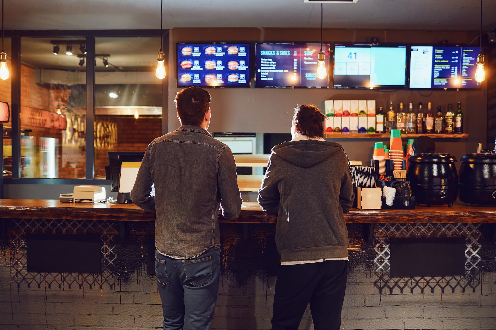 two men at counter of bar