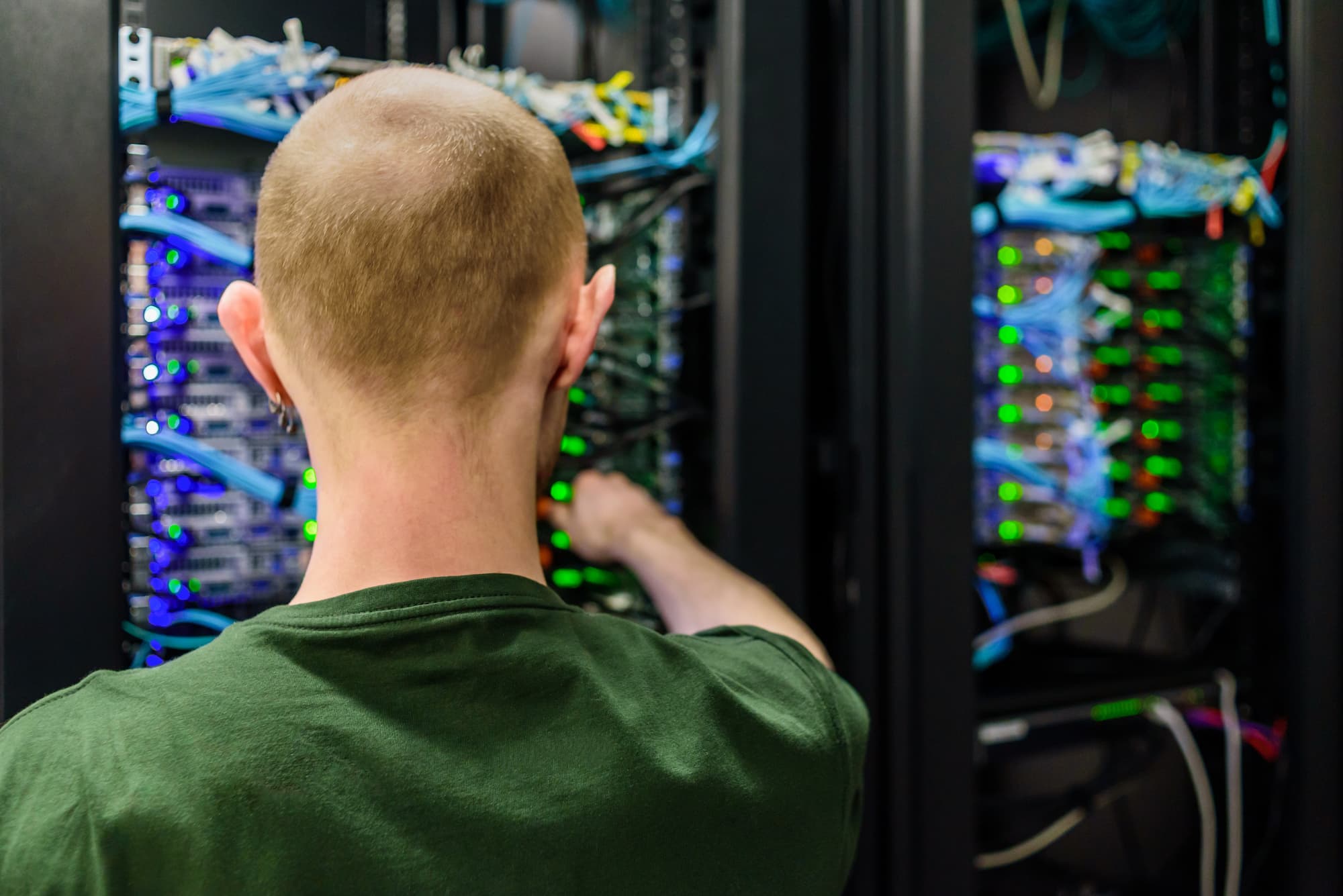 IT service technician arranging cables in server