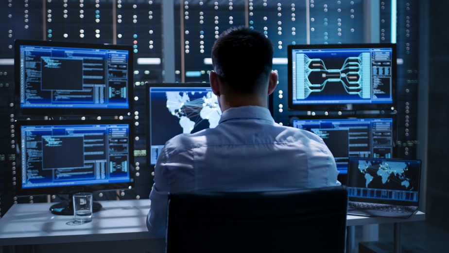 global IT dispatch technician in front of monitors