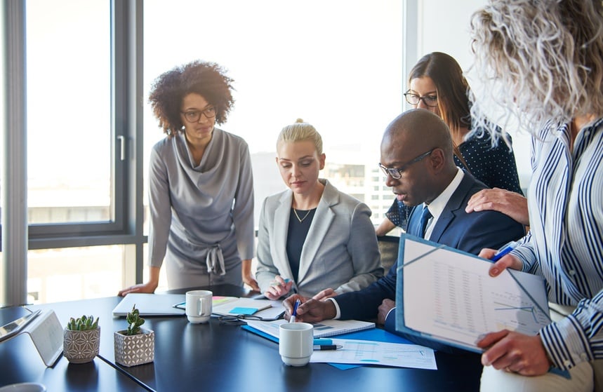 corporate employees discuss their research in a conference room