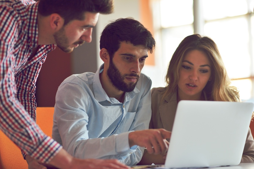 group choosing field service management software on a laptop