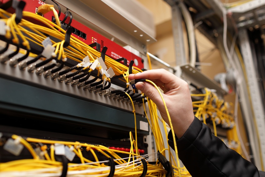 IT service technician plugging in cables