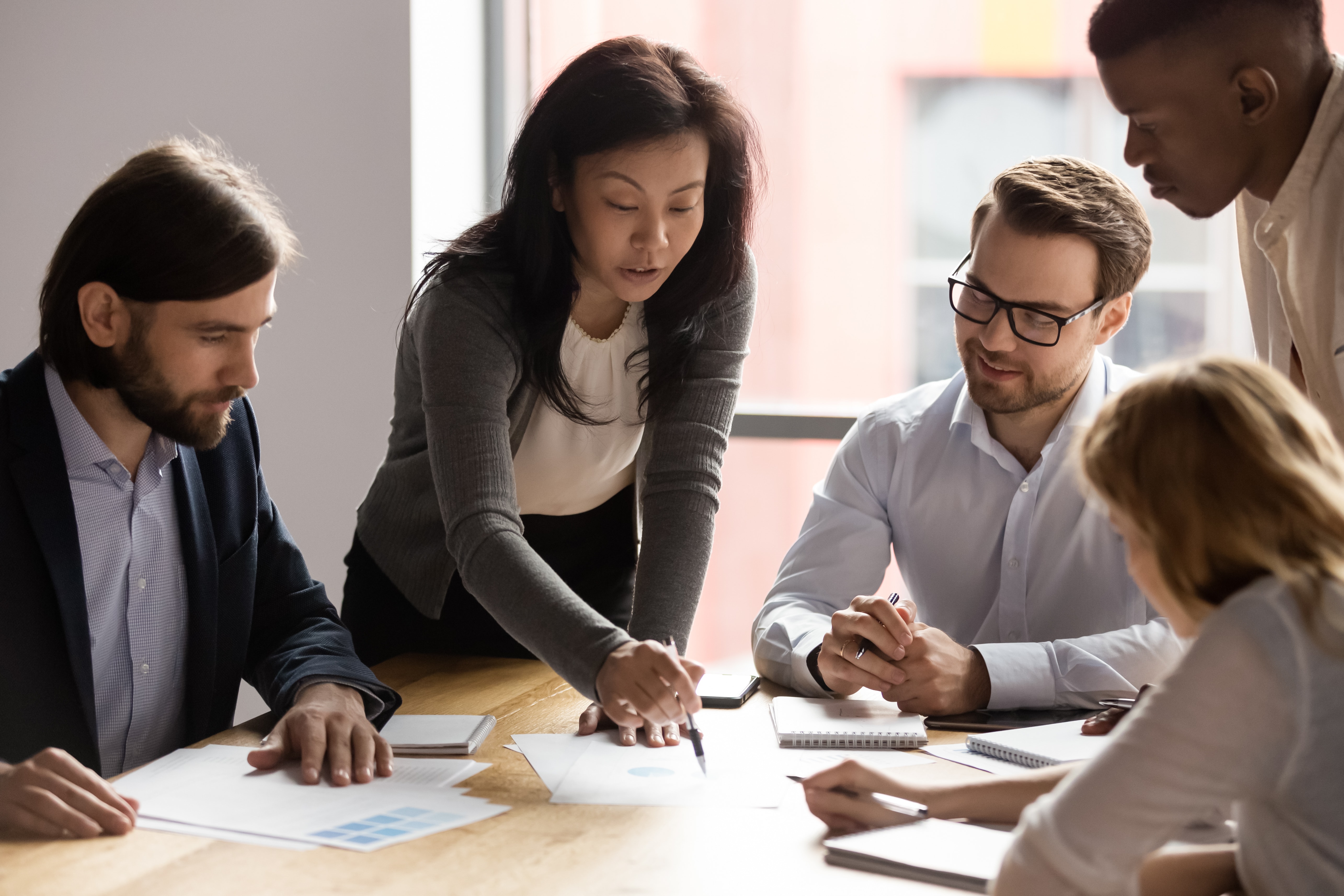 colleagues communicate business plans with each other at a table 