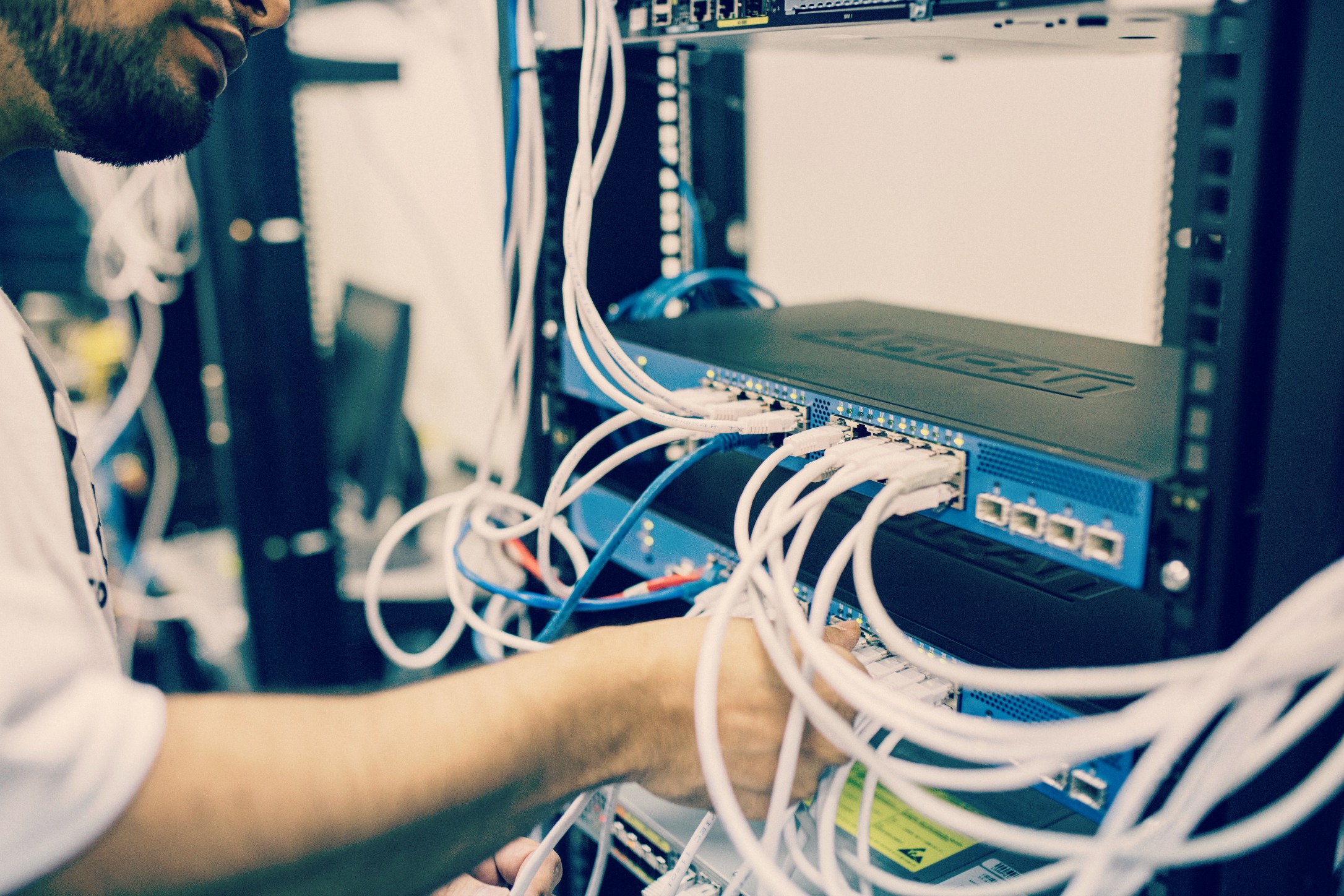 IT field service technician installing cables